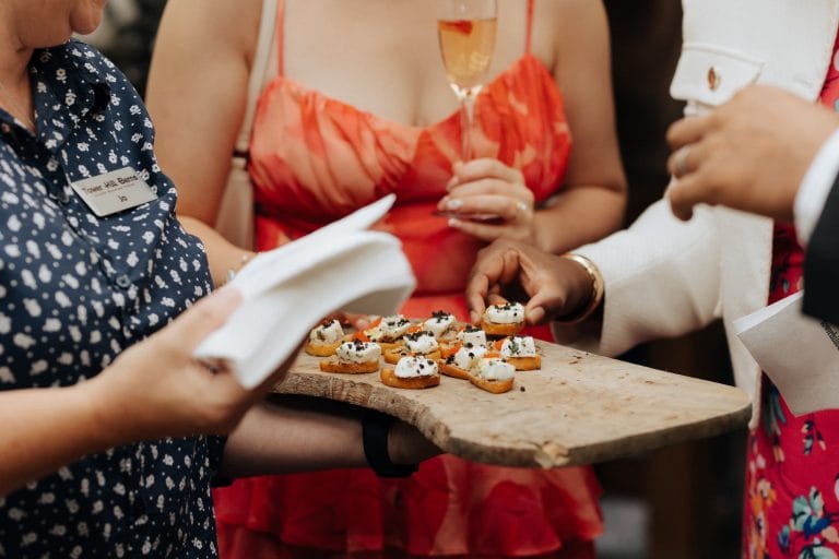 Canapés served during wedding reception on the terrace at Tower Hill Barns in the summer